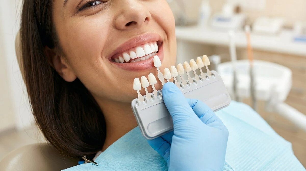 Dentist matching a filling shade to a patient's natural teeth