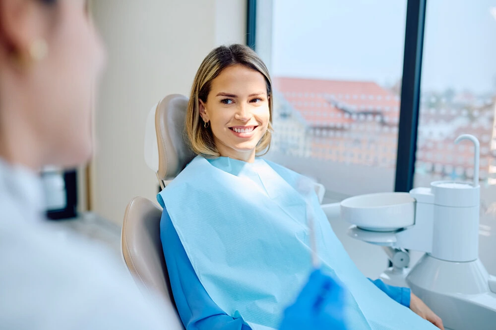 Smiling patient in a dental chair during a cosmetic consultation
