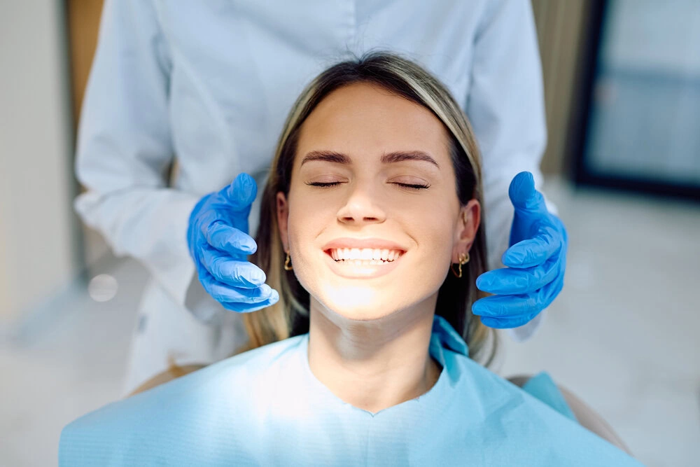 Patient with a bright white smile after cosmetic dental care