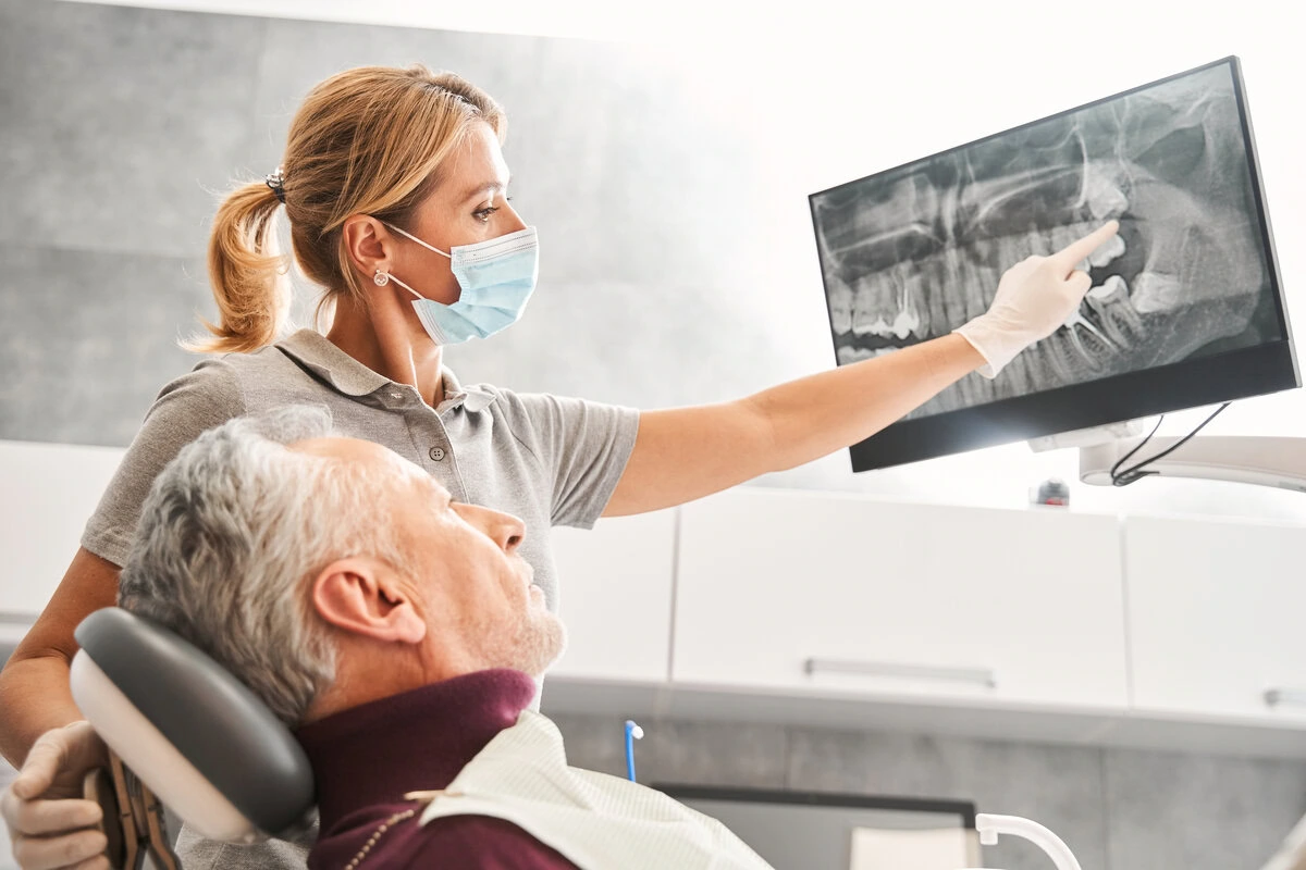 Older patient reviewing her treatment plan on a screen