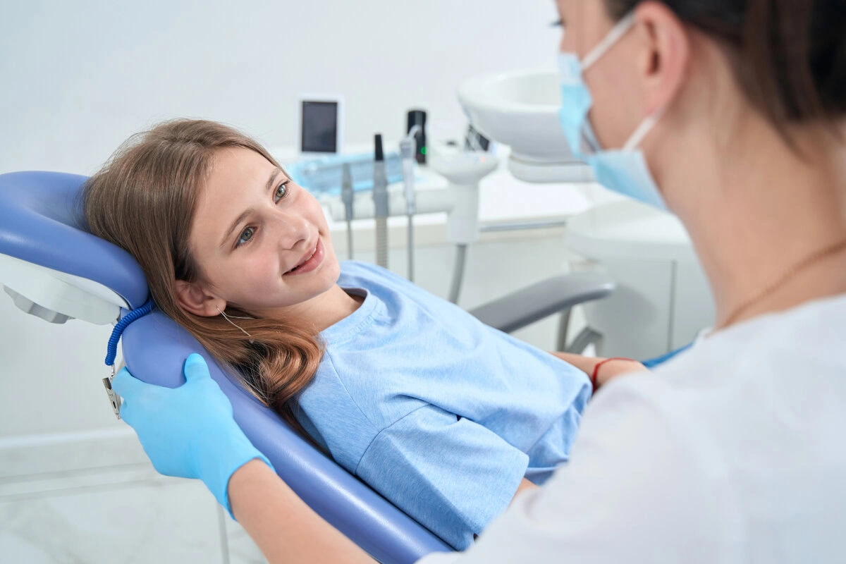 Smiling child in the dental chair at her first visit