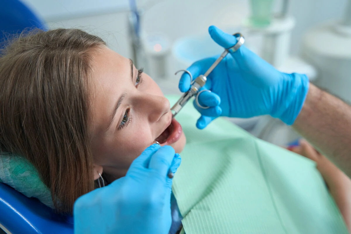 Child receiving a dental checkup in the chair