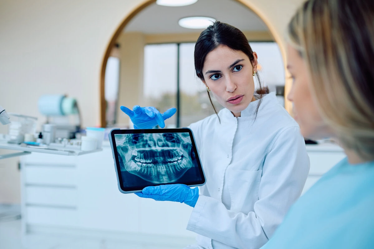 Dentist reviewing a dental X-ray with a patient