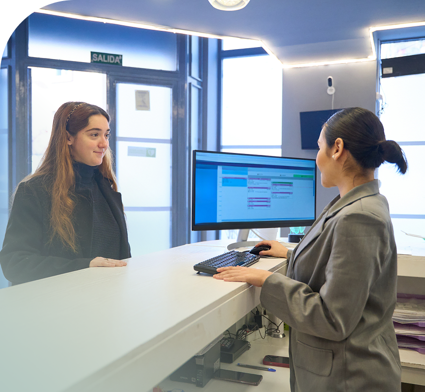Front desk team member greeting a patient at check-in