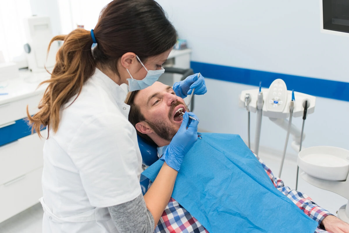 Dental team member preparing a patient for a tooth extraction